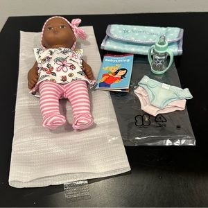 American Girl Caring for Baby Doll and Accessories